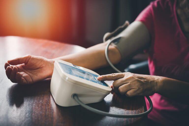 woman's upper arm while taking her blood pressure