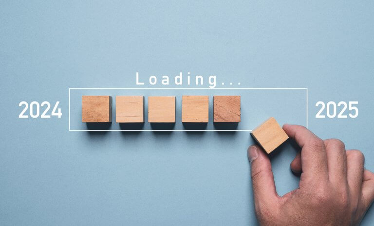 Hand assembling wooden block cube to update technology downloading tool bar status from 2024 to 2025